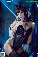 A woman in a black and white outfit posing for a picture.