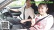 A man and a woman sitting in a car.