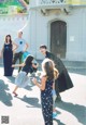 A group of people playing with bubbles in front of a building.